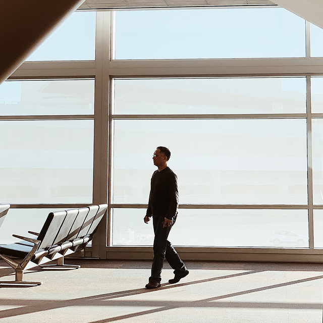 Passenger walking through a bright airport terminal